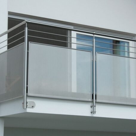 Moderner Balkon mit Metallgeländer an weißer Hausfassade, große Glas-Schiebetür im Hintergrund. HANSEL.kraus metalltechnik gmbh