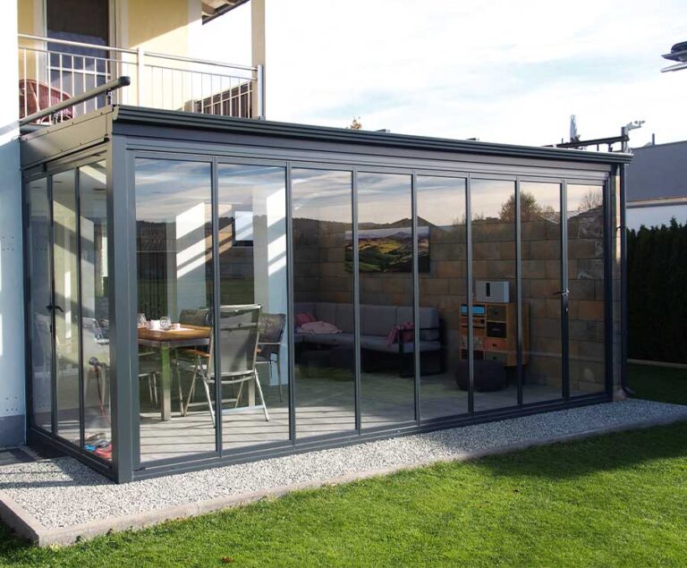 Modernes Glas-Terrassenzimmer mit Esstisch und Stühlen hinter einer Glasfassade im Garten. HANSEL.kraus metalltechnik gmbh
