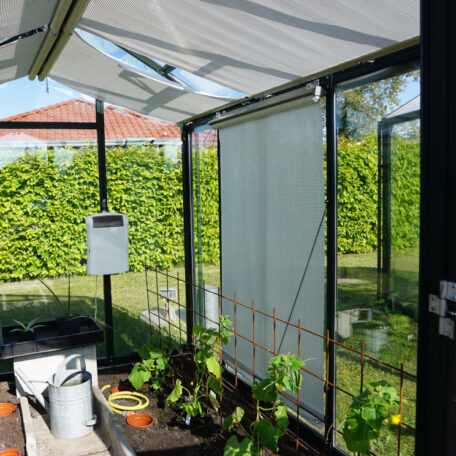 Gemüsebeete und Geräte in einem modernen, sonnendurchfluteten Gewächshaus im Garten. de HANSEL.kraus metalltechnik gmbh